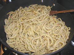 Pici, cooked and tossed with sauce