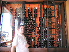 Minna - owner Fernando and his wall of wine