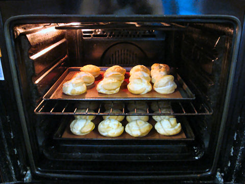 Profiteroles, or cream puffs, baking