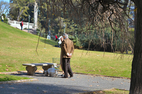 Men walking dog on Plaza Francia