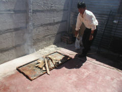Miguel builds the fire for our asado