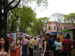 Tourists throng the streets of the Feria de Mataderos